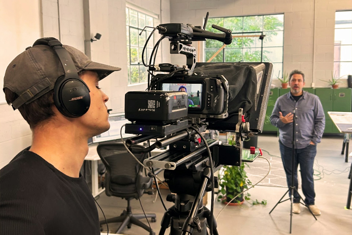 Filming a man speaking in a studio setting.